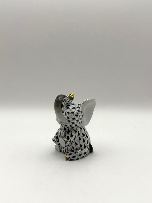 Small Baby Elephant Sitting Trunk Up Black