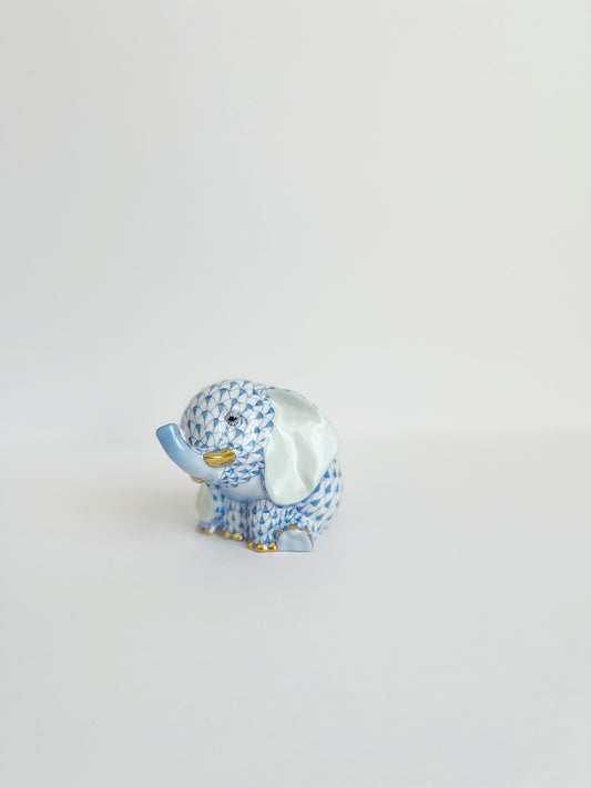 Baby Elephant Sitting Trunk Up Blue